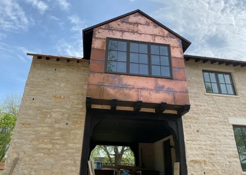 Copper metal panel facade on a stone building for Skylight Installation in Short Pump